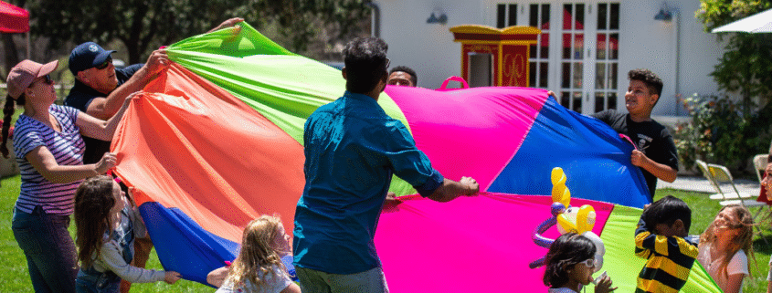 Group Playing Parachute Volleyball at San Jose Company Picnic Spot