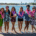 Group Posing with Branded Fresh Coconuts and Leis at Edwards' Luxury Luau Themed Employee Appreciation Outing in Newport Beach, CA