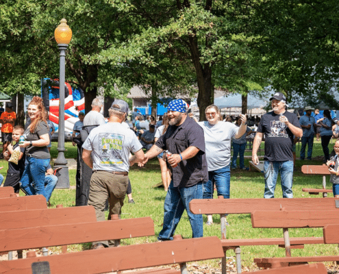 Group Cheering During Field Games at GBRX's Team Building Day in Rector, Arkansas