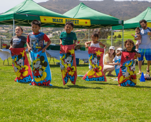 Kids Having a Field Game of Potato Sack Race at inVia Robotics' Family Day in Malibu